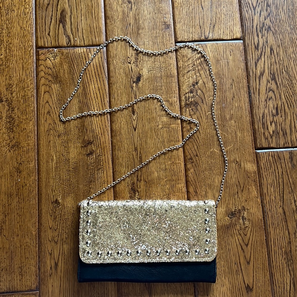 BLack and gold small satchel bag. Gold chain. Double pockets inside.